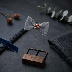 Elegant Silver Bow Tie Lapel Pin with Antique Gold Center