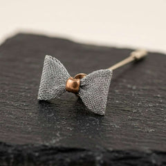 Elegant Silver Bow Tie Lapel Pin with Antique Gold Center