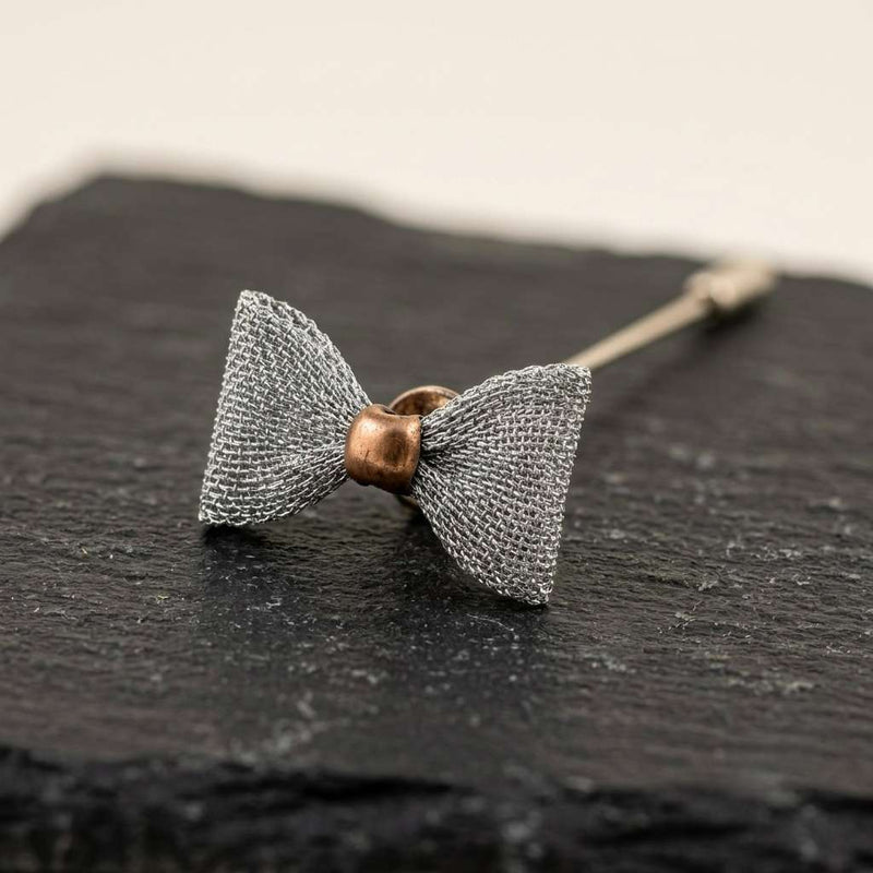 Elegant Silver Bow Tie Lapel Pin with Antique Gold Center